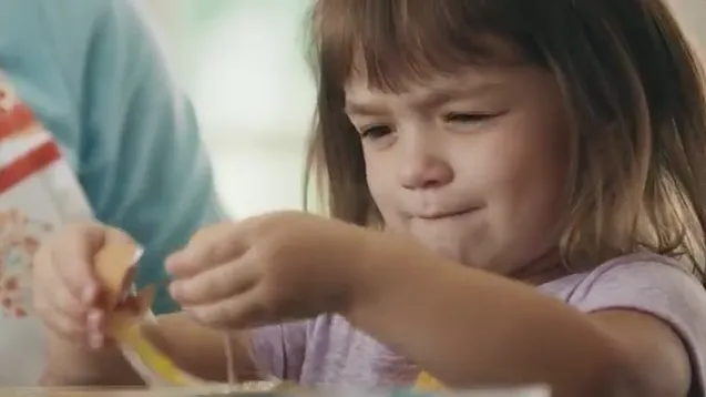 A young child working at a table in CollegeInvest — Piece of Cake