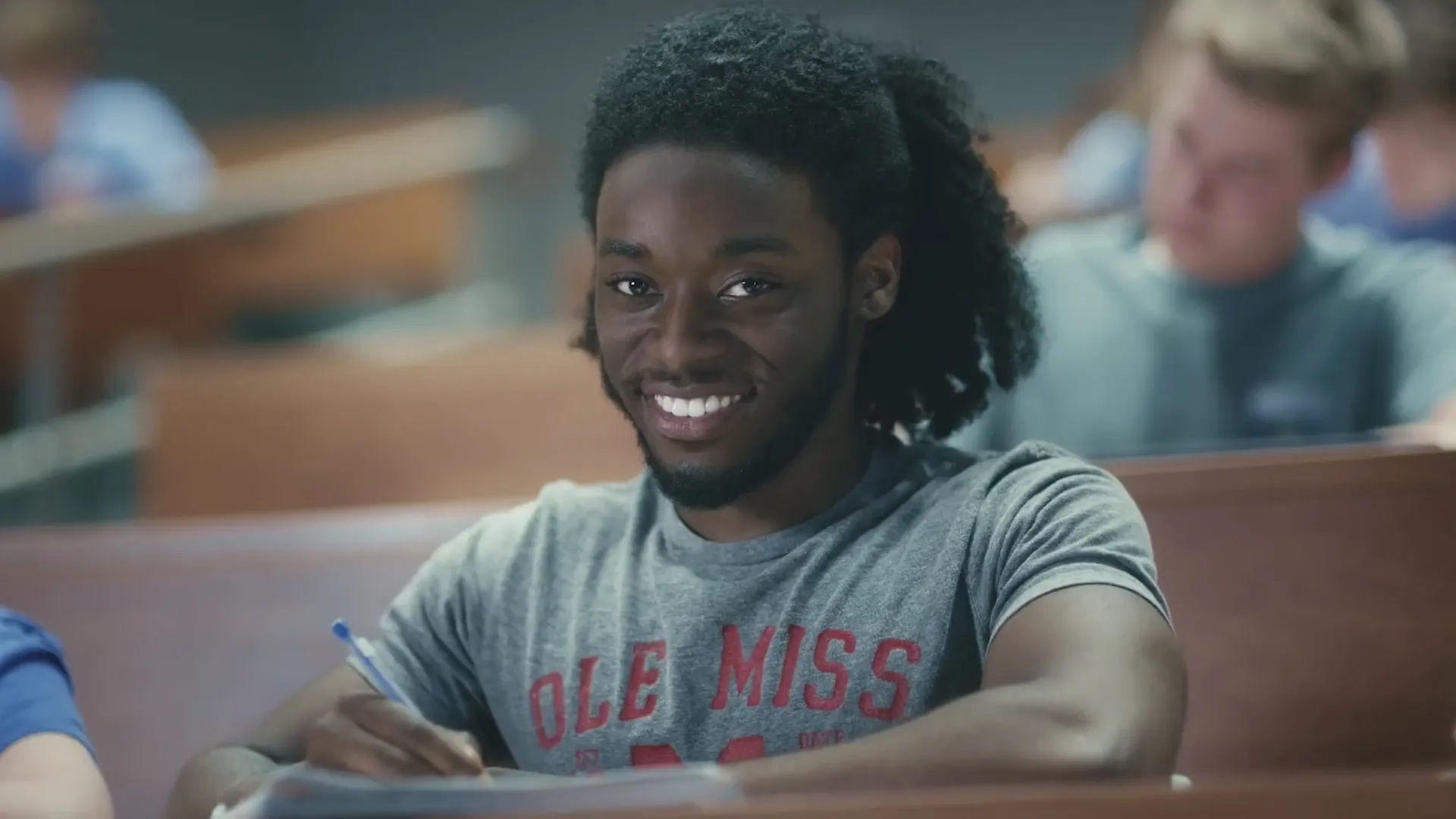 Smiling Ole Miss student seated in a lecture hall