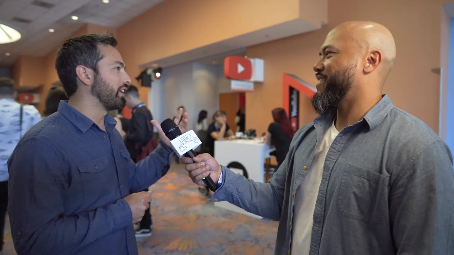 An interviewer speaking with a guest at VidCon 2018